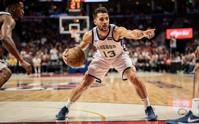 NBA point guard dribbling ball during game action